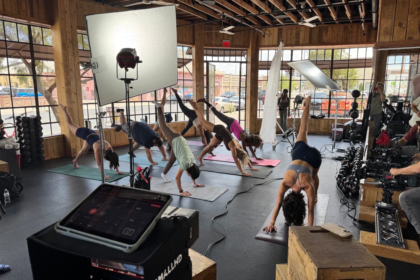 A large soft source keying a wide studio setup while a scene is shot
